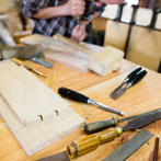 Ben Casson making a shelving unit in his workshop at Wobage Farm 2016
